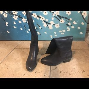 Black below the knee length boots. Flat heel